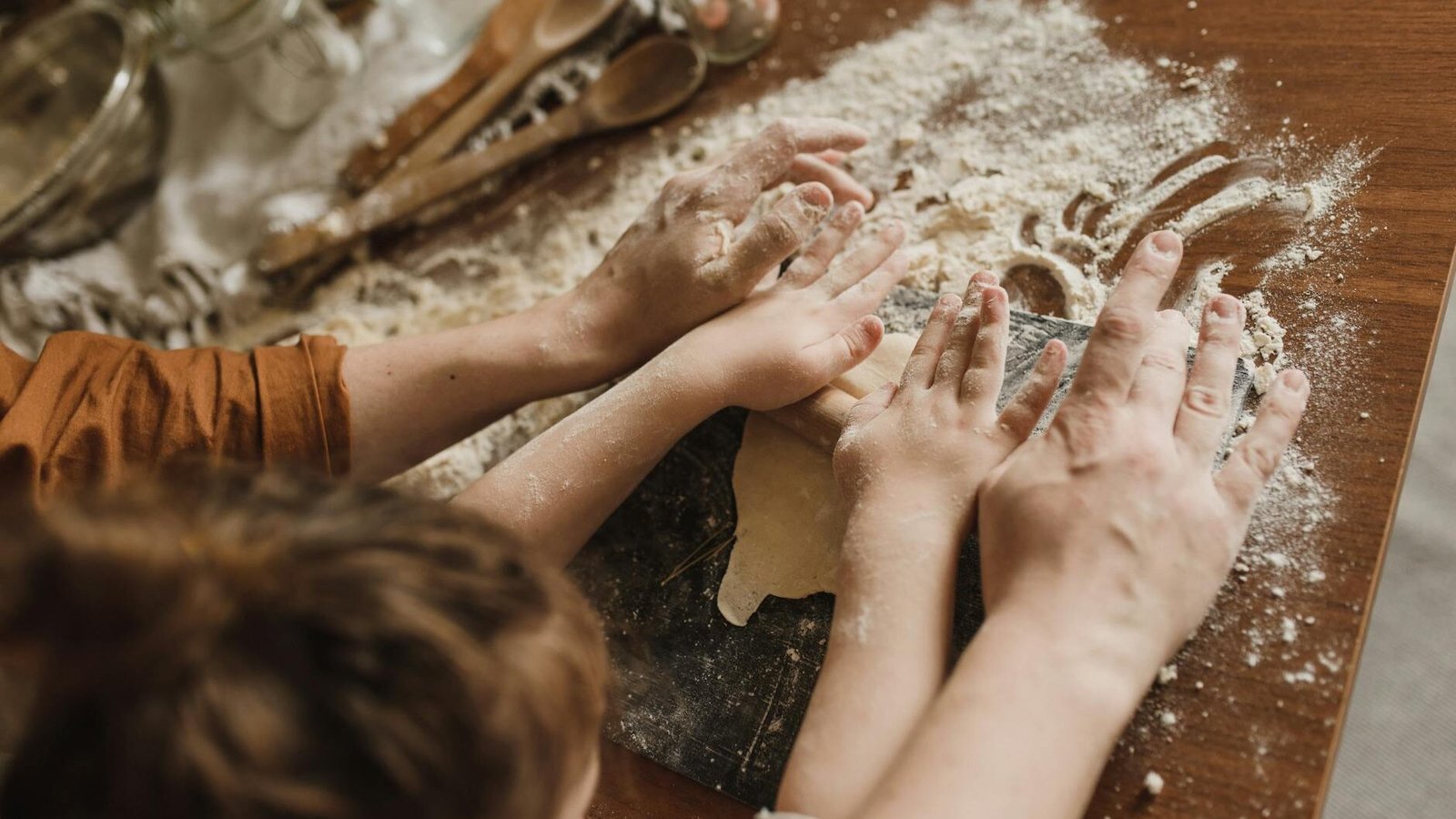 a parent and a child kneading dough