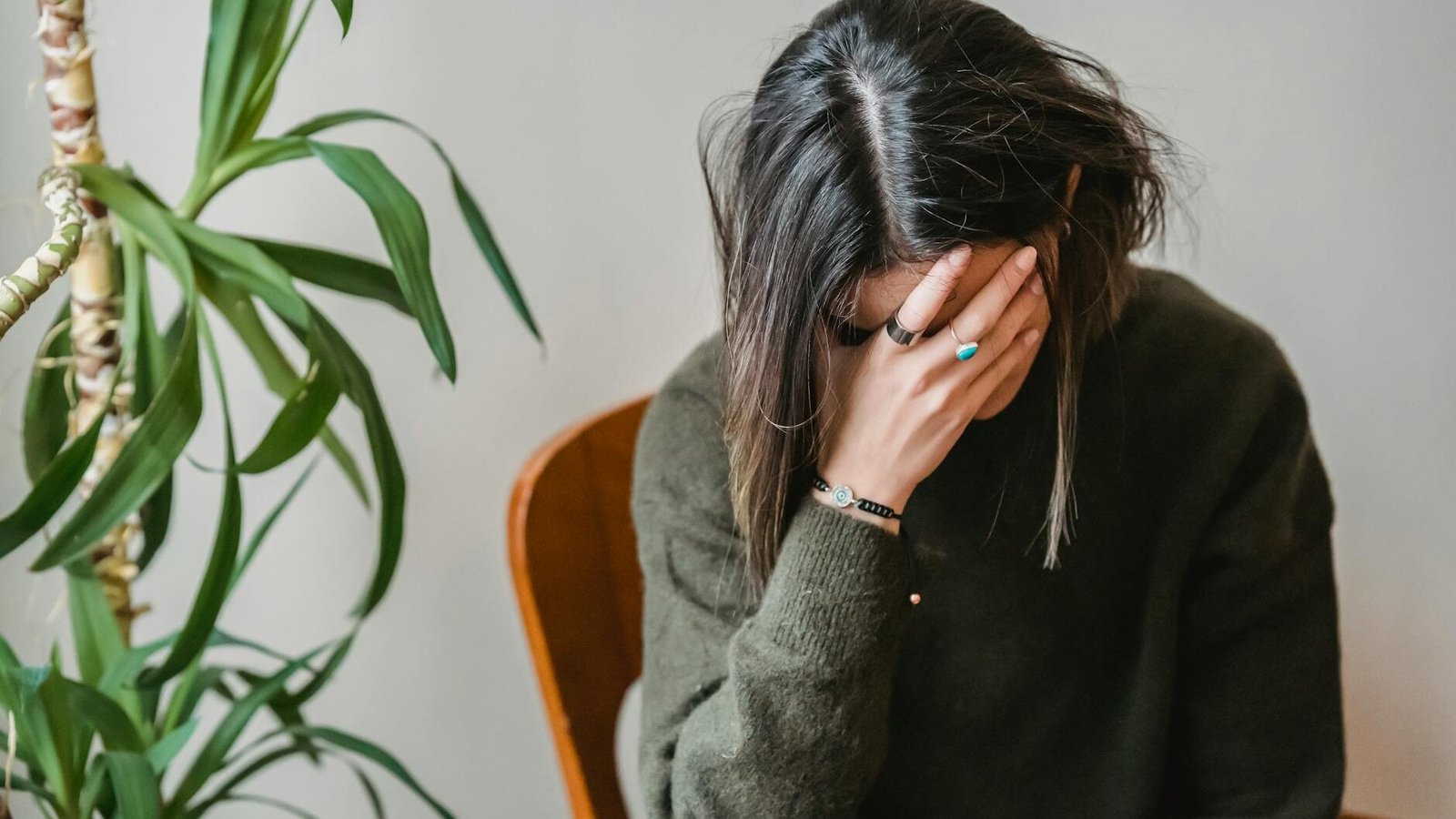 worried young woman covering face with hand