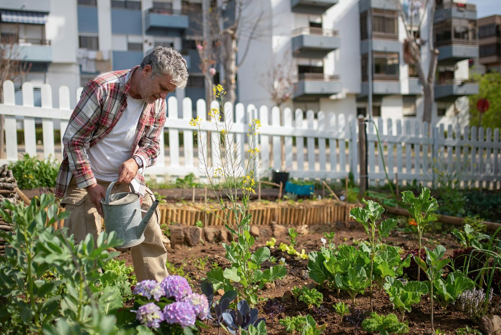 man watering his plants
